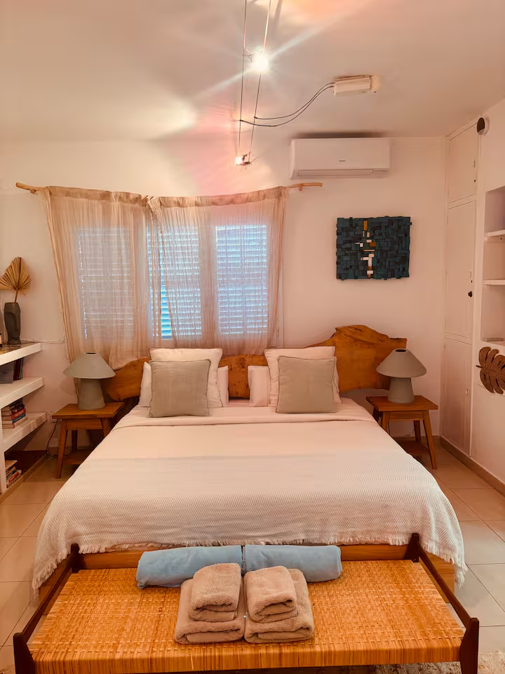 Bright bedroom with live-edge headboard and linen drapes