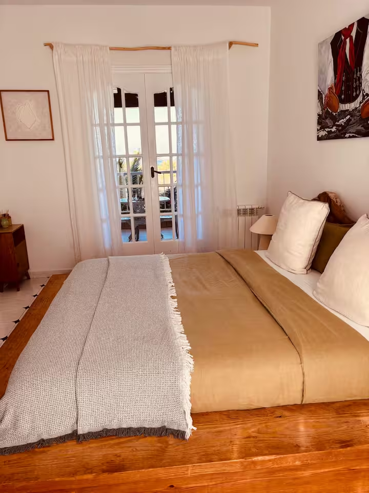 Bedroom with french doors opening to a balcony