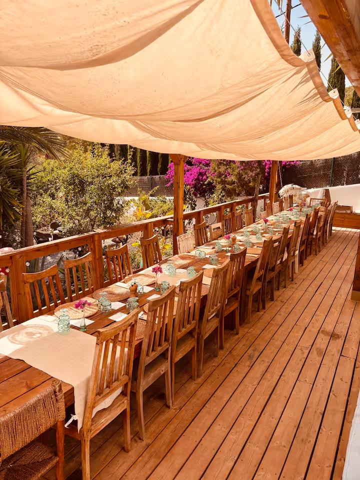 Shaded outdoor dining deck set for a long lunch